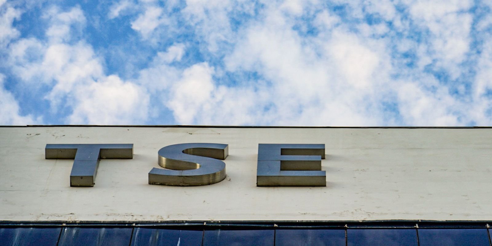 Fachada do TSE em Brasília, com a sigla do tribunal sob o céu.